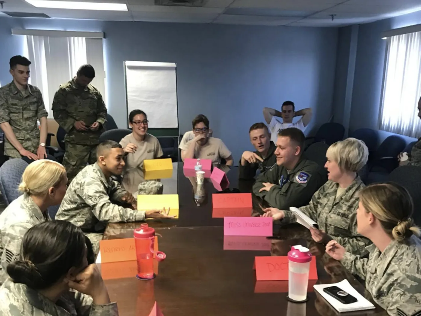 Service members in a small-group leadership discussion